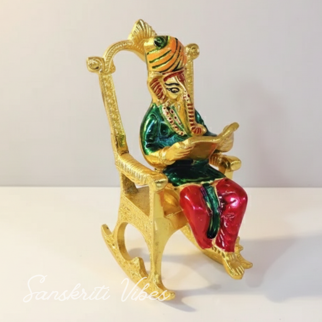 Modern Chair Ganesha Metal Statue Reading Ramayan with Meenakari Work Aluminium Ganesh Showpiece for Home Decor and Auspicious Gifting
