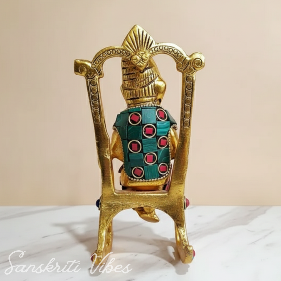 Modern Chair Ganesha Metal Statue Reading Ramayan with Stone Work Showpiece for Home Glossy Finish Ganpati Idol