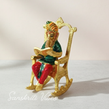 Modern Chair Ganesha Metal Statue Reading Ramayan with Meenakari Work Aluminium Ganesh Showpiece for Home Decor and Auspicious Gifting