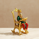Modern Chair Ganesha Metal Statue Reading Ramayan with Meenakari Work Aluminium Ganesh Showpiece for Home Decor and Auspicious Gifting